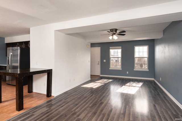 spare room with dark hardwood / wood-style floors and ceiling fan