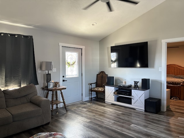 living room with ceiling fan, lofted ceiling, and dark hardwood / wood-style floors