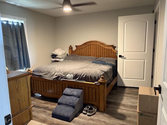 bedroom with ceiling fan and dark hardwood / wood-style flooring