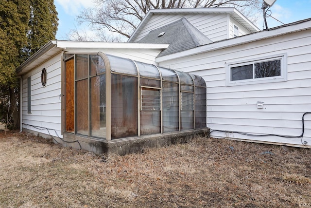 view of side of home featuring a sunroom