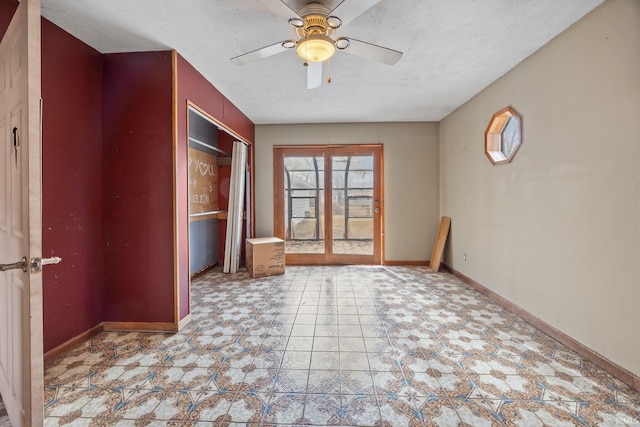 empty room featuring a textured ceiling and ceiling fan