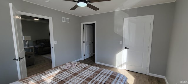 bedroom featuring dark hardwood / wood-style flooring and ceiling fan