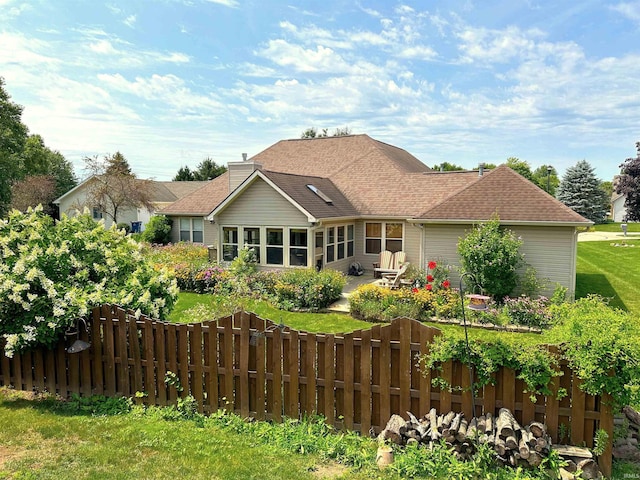 rear view of house with a yard and a patio area