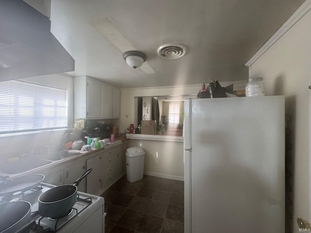 kitchen with white cabinets and white appliances