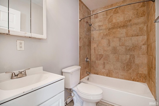 full bathroom featuring tiled shower / bath combo, vanity, and toilet