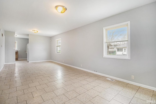 spare room with light tile patterned floors