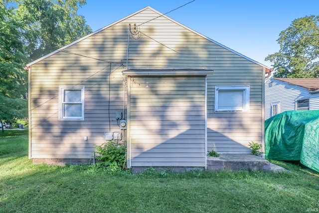 rear view of house with a yard