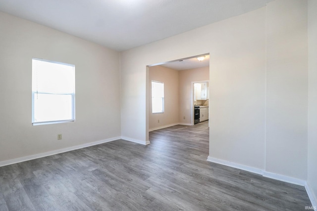 unfurnished room featuring dark hardwood / wood-style flooring