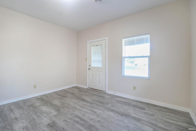 empty room with light hardwood / wood-style floors