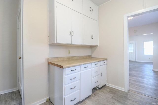 kitchen featuring white cabinetry and light hardwood / wood-style flooring