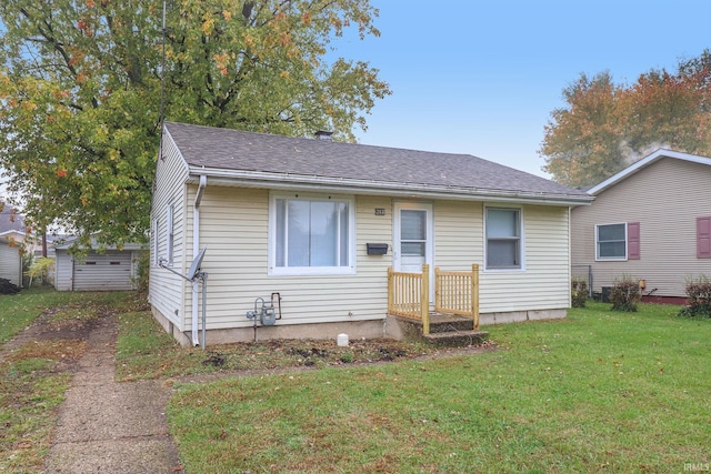 bungalow-style home featuring a front yard