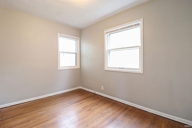 unfurnished room featuring hardwood / wood-style flooring