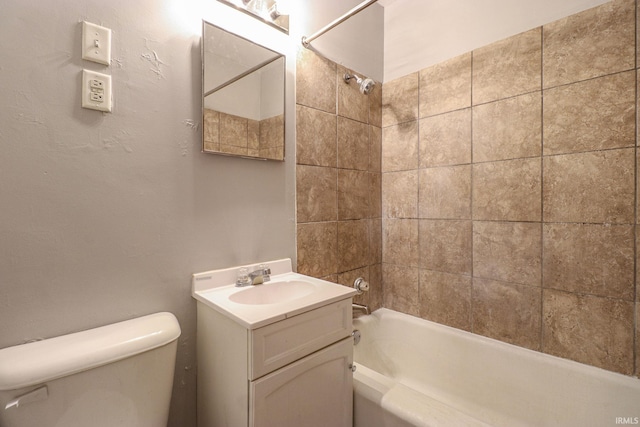 full bathroom featuring vanity, toilet, and tiled shower / bath combo