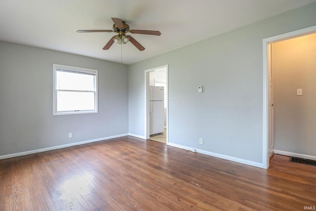 unfurnished room with ceiling fan and dark hardwood / wood-style floors