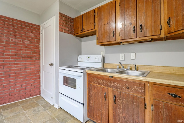 kitchen featuring brick wall, white electric stove, and sink