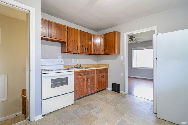 kitchen featuring ceiling fan, white appliances, and sink