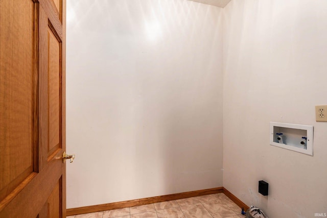 washroom with washer hookup and light tile patterned floors