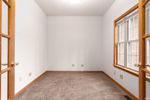 empty room with plenty of natural light and light carpet