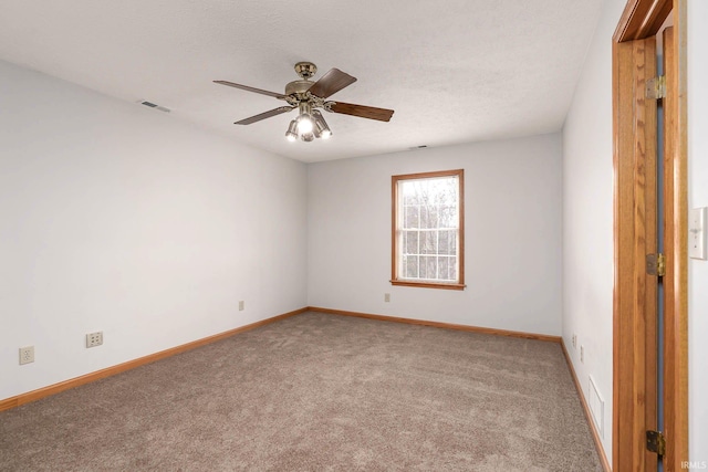 carpeted empty room with a textured ceiling and ceiling fan