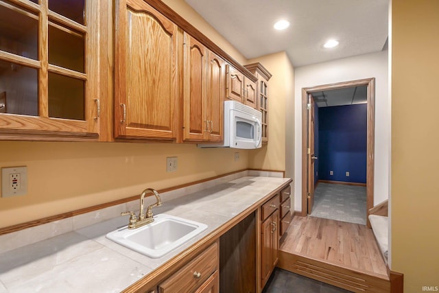 kitchen with tile countertops, dark hardwood / wood-style flooring, and sink