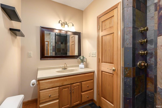 bathroom featuring vanity and toilet