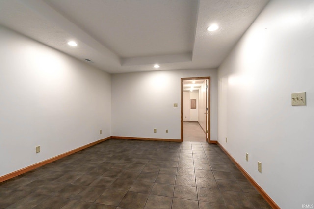 spare room featuring a raised ceiling