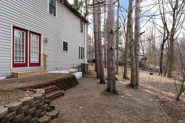 view of yard with a patio area and central air condition unit