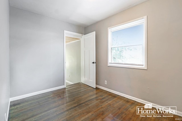 unfurnished room with dark hardwood / wood-style floors