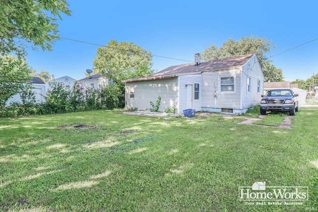 back of property featuring a yard