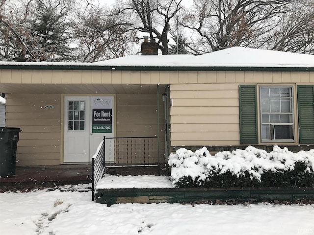 view of snow covered property entrance