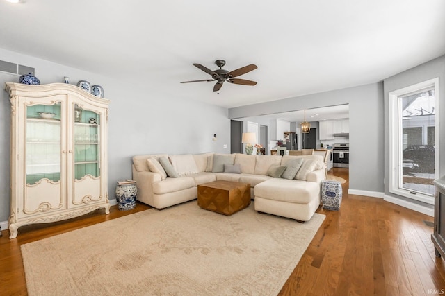 living room with ceiling fan and wood-type flooring