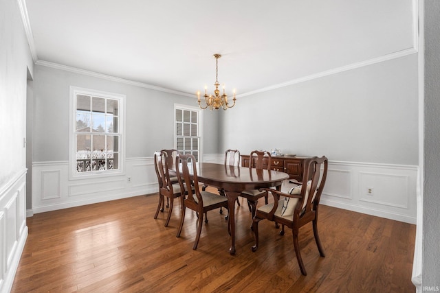 dining area with an inviting chandelier, crown molding, and dark wood-type flooring