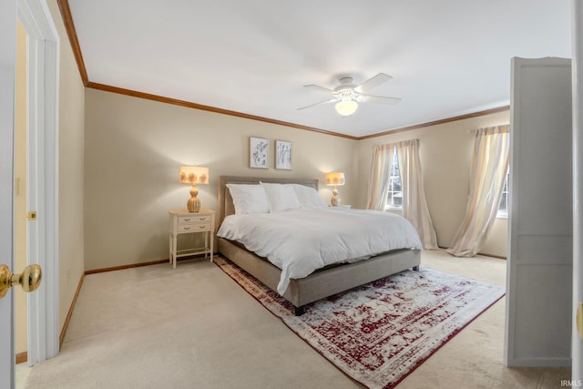 carpeted bedroom featuring ceiling fan and ornamental molding