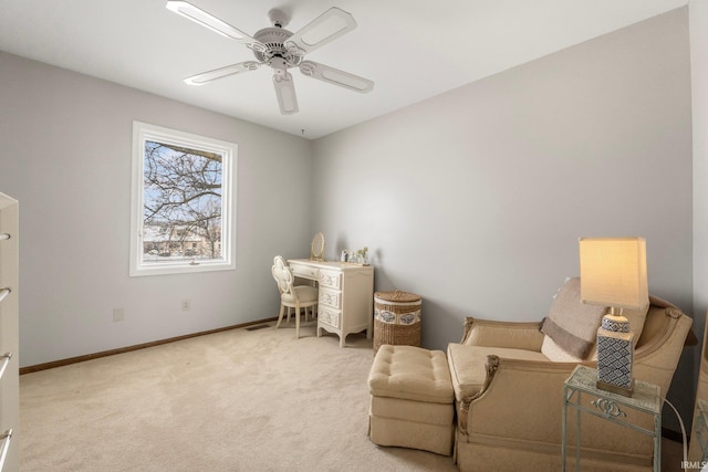 sitting room featuring light carpet and ceiling fan