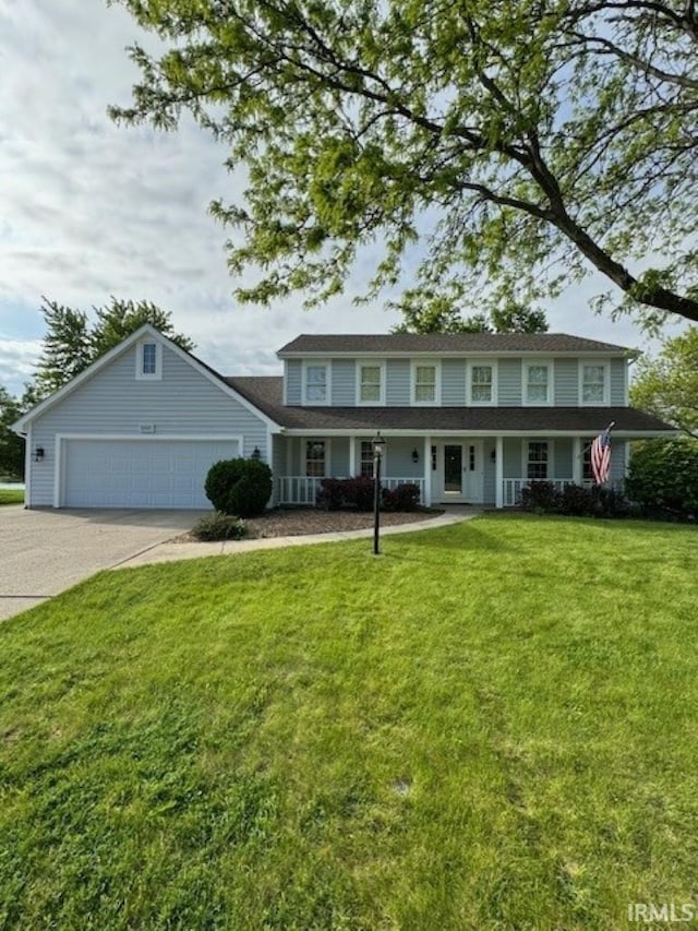 view of front facade with a porch, a garage, and a front yard