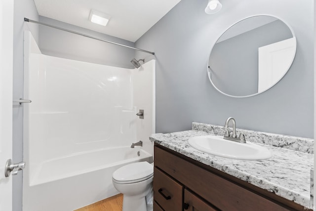 full bathroom with vanity, toilet, shower / bath combination, and hardwood / wood-style floors