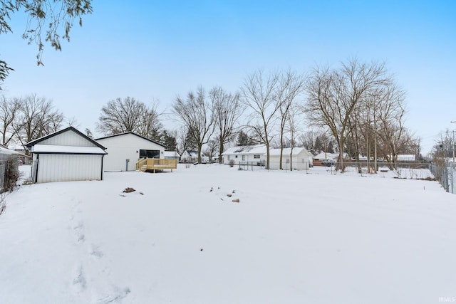 snowy yard featuring a garage