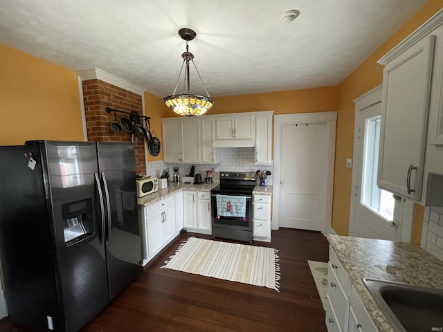 kitchen with decorative light fixtures, light stone countertops, white cabinets, and appliances with stainless steel finishes