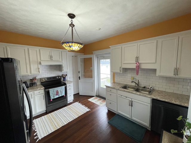 kitchen featuring pendant lighting, white cabinets, sink, and black appliances