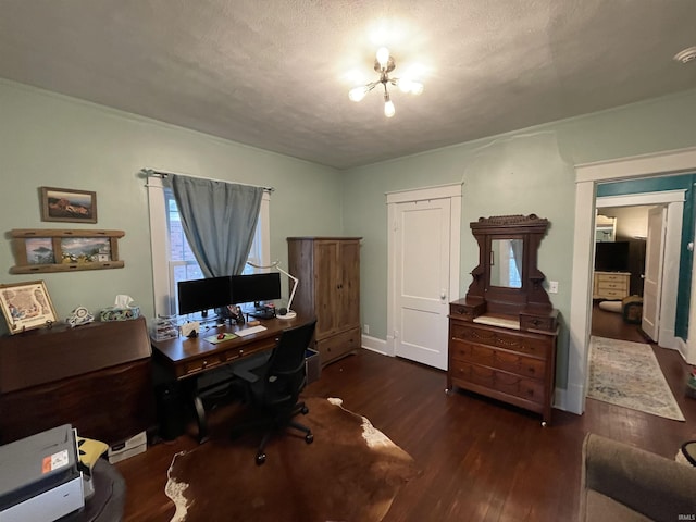 home office featuring dark hardwood / wood-style floors and a textured ceiling