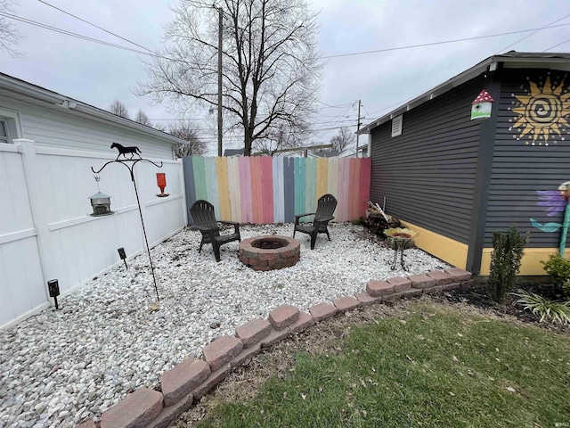 view of yard with a fire pit