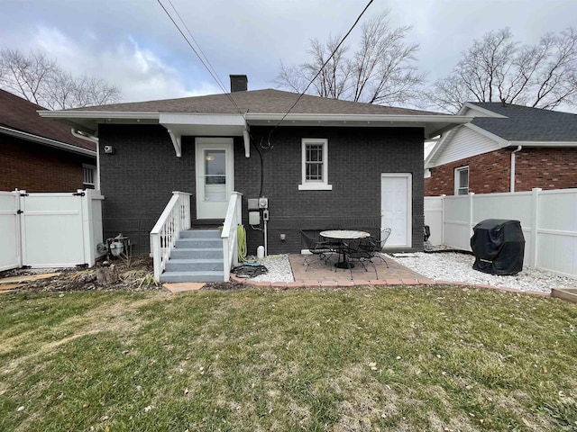 back of house featuring a yard and a patio area