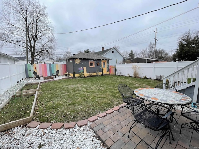 view of yard featuring an outbuilding and a patio area