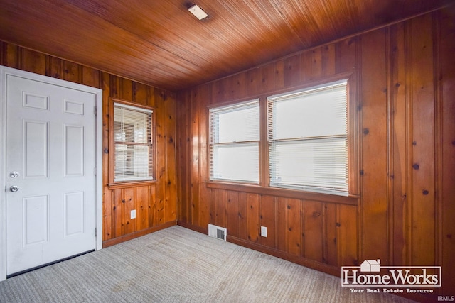 interior space featuring wood ceiling and wooden walls