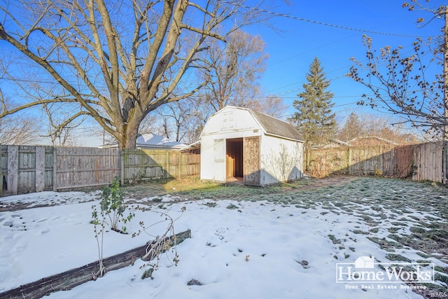 yard covered in snow with a shed