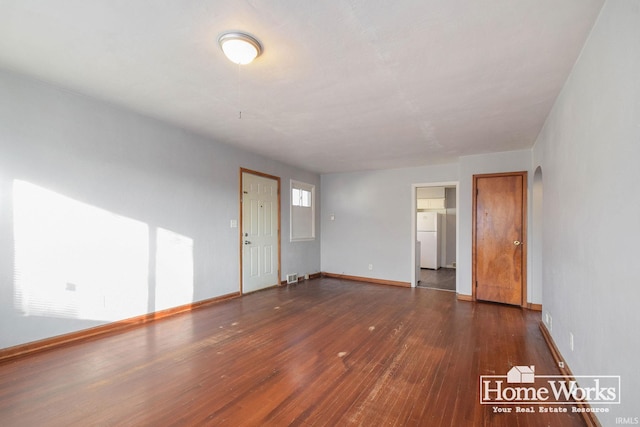 unfurnished room with dark hardwood / wood-style flooring