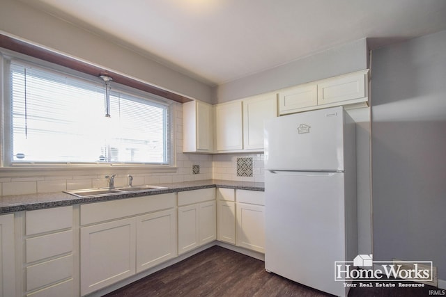 kitchen featuring white refrigerator, sink, white cabinets, and dark hardwood / wood-style flooring