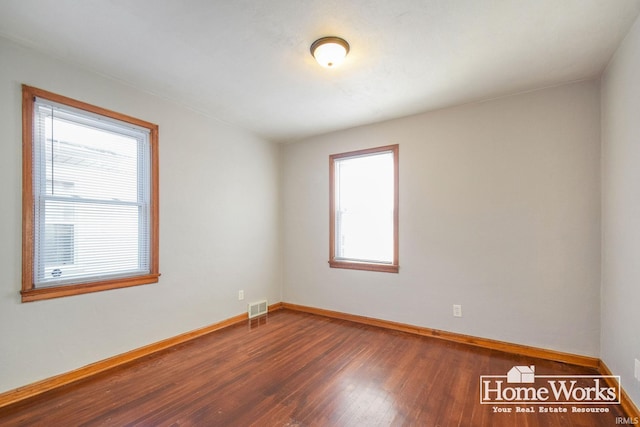 empty room with dark wood-type flooring