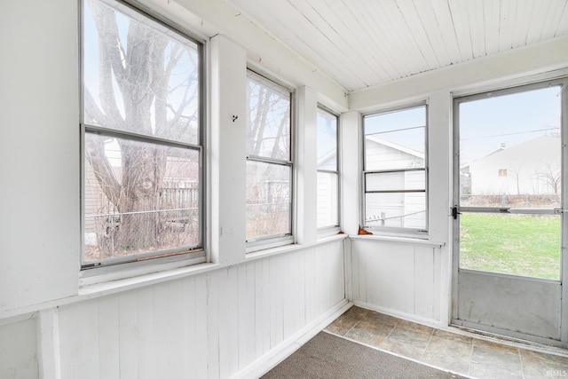 unfurnished sunroom with wooden ceiling