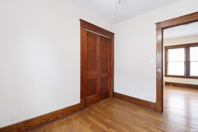 empty room with hardwood / wood-style flooring